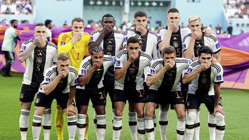 Germany players cover their mouths as they pose for a team group before their World Cup game with Japan. FIFA was also criticised in the first week of the tournament after threatening sporting sanctions against the seven European nations who wanted their captains to wear a rainbow-coloured &#39;OneLove&#39; armband as an anti-discrimination symbol 