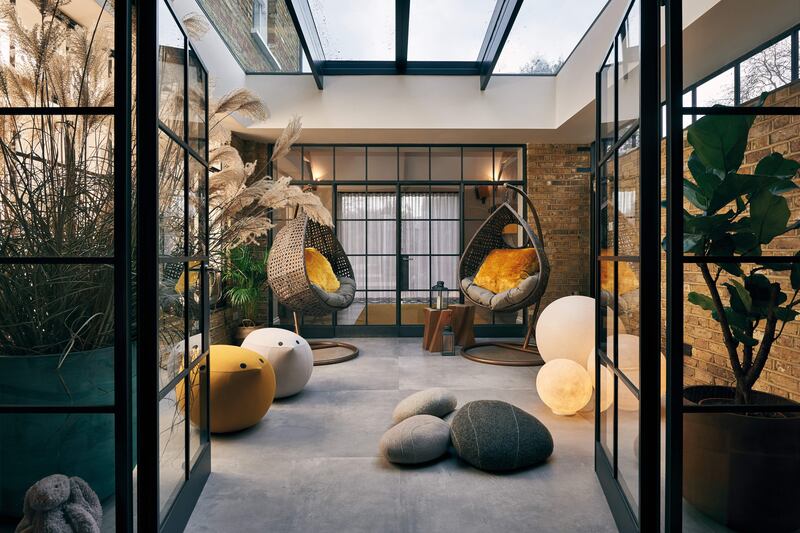 The glass doors in this indoor courtyard create a semi-private space that still feels connected to the rest of the home