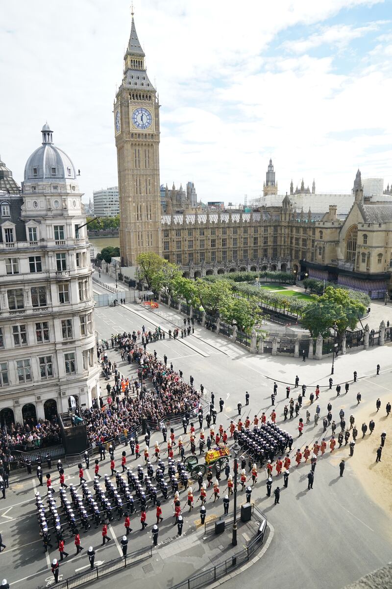 The State Gun Carriage carries the coffin of Queen Elizabeth II, draped in the Royal Standard with the Imperial State Crown and the Sovereign's orb and sceptre, in the Ceremonial Procession following her State Funeral at Westminster Abbey
