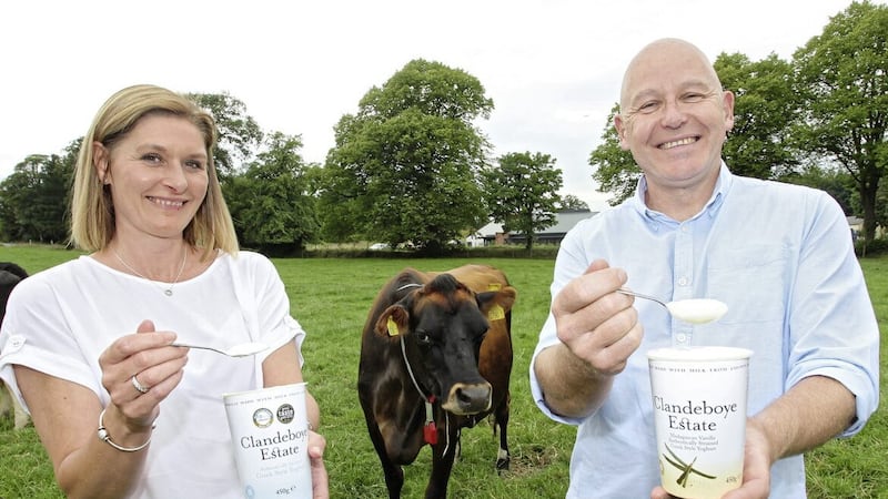 Nichola Lockhart, chief executive of Ards Business Hub, with Clandeboye Estate Yoghurt general manager Bryan Boggs and Cookie the cow 