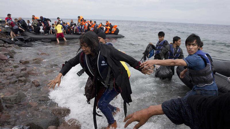 Migrants arrive on the shores of the Greek island of Lesbos yesterday. Picture by Petros Giannakouris/AP Photo              
