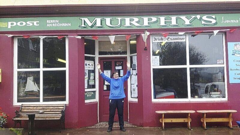 Mary Murphy, who sold the winning lottery ticket, pictured outside her post office on Bere Island. Picture by RTE. 