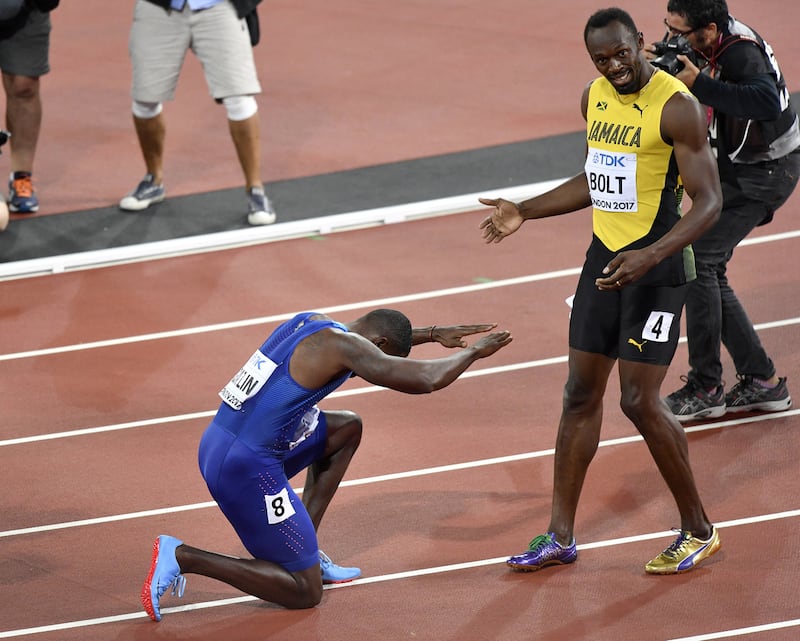 United States' Justin Gatlin, left, bows to Usain Bolt