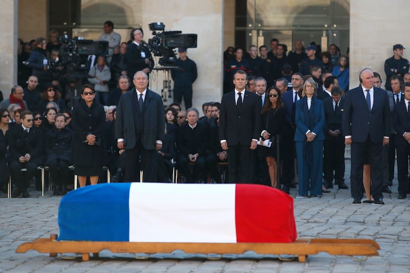 French President Emmanuel Macron stands behind the coffin of Charles Aznavour