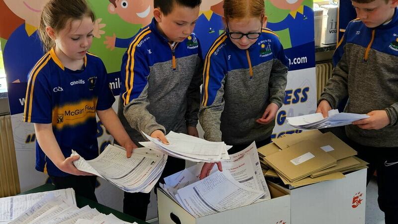 Pupils at St Mary's Primary in Fivemiletown sort through letters of support to keep the school open.