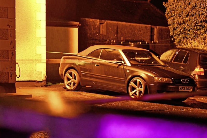 A car at the farmhouse on Church Road at Glenwherry which remained cordoned off on Tuesday night. Picture by Alan Lewis/Photopress