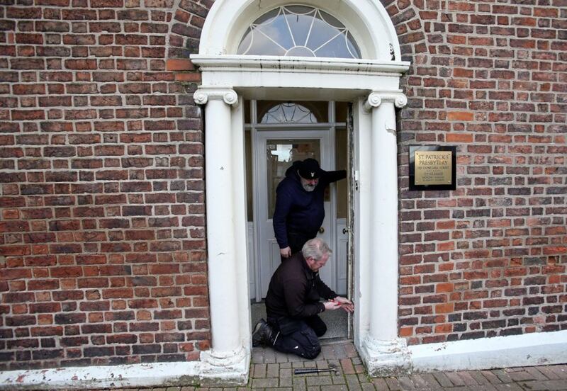 The removal of the iconic brass door for repair from St Patrick's Presbytery in Donegall Street, Belfast. Picture by Mal McCann