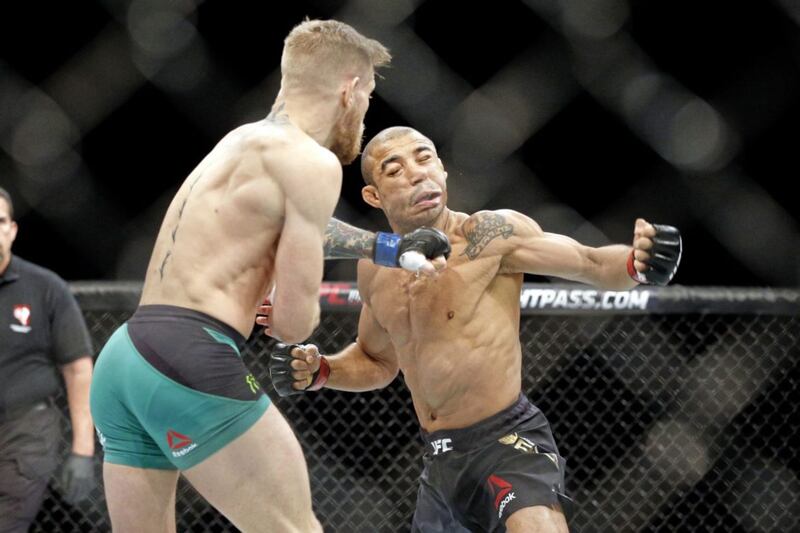 Conor McGregor knocks out  Jose Aldo during a featherweight championship mixed martial arts bout at UFC 194, Saturday, Dec. 12, 2015, in Las Vegas. (AP Photo/John Locher). 