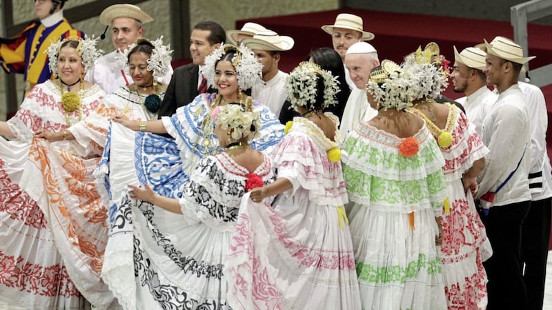 Faithful wearing traditional costumes from Panama pose for a family picture with Pope Francis during the weekly general audience at the Vatican. Picture by Gregorio Borgia/AP 