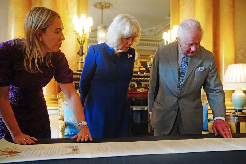 Charles and Camilla with Antonia Romeo, Clerk of the Crown in Chancery, viewing the Coronation Roll