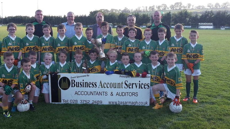 Na Piarsaigh &Oacute;ga U10s, Armagh, who won the Donal Powell Memorial Tournament at Pearse &Oacute;g Park. Pictured with the winning team are mentors Paul and Martin and manager Tony, club chairman Paul Sanders and tournament sponsor Gerard Davidson of Business Account Services