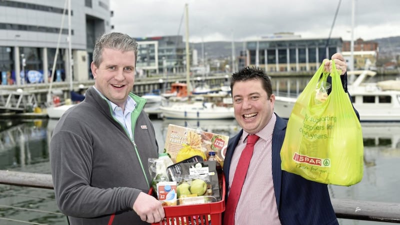 James Eyre, (left) commercial director at Titanic Quarter, and Andy Davis, co-owner of Spar Titanic Quarter, celebrate the opening of the new larger store 