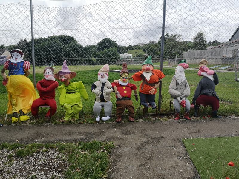 Scarecrow figures of Snow White and the Seven Dwarves made by the children from the local school in Llysfaen