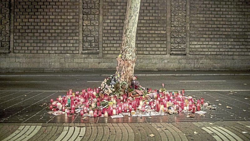 A memorial tribute of flowers, messages and candles to the van attack victims is seen on the historic Las Ramblas promenade, in Barcelona, Spain, yesterday. Picture by Santi Palacios, Associated Press 
