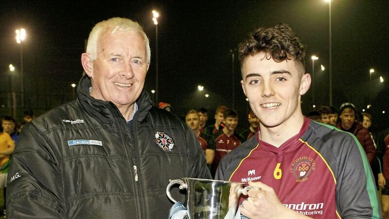 Sean McAlinden, captain of St Ronan's Lurgan, receives the McCormack Cup from Jimmy Smith after November's final victory<br />Picture by Jim Dunne