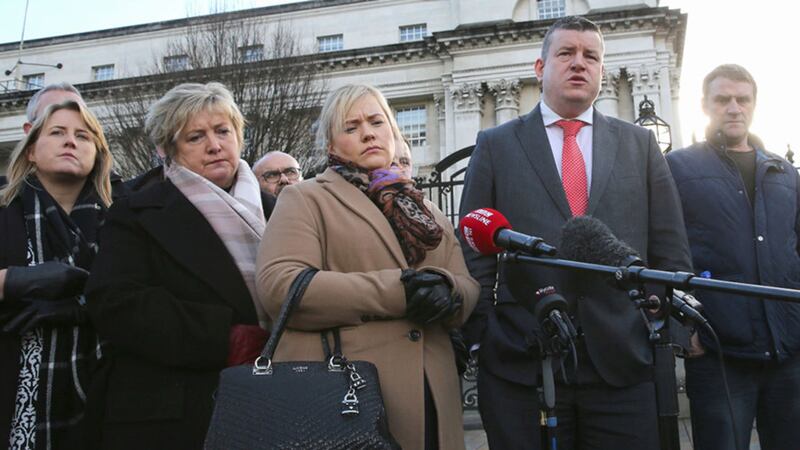 Emma Rogan, daughter of Adrian Rogan who died in the Loughinisland massacre and other victims' relatives speak to the media outside Belfast High Court. Picture by Hugh Russell&nbsp;