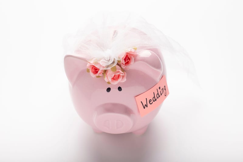 Piggy bank decorated with wedding bouquet