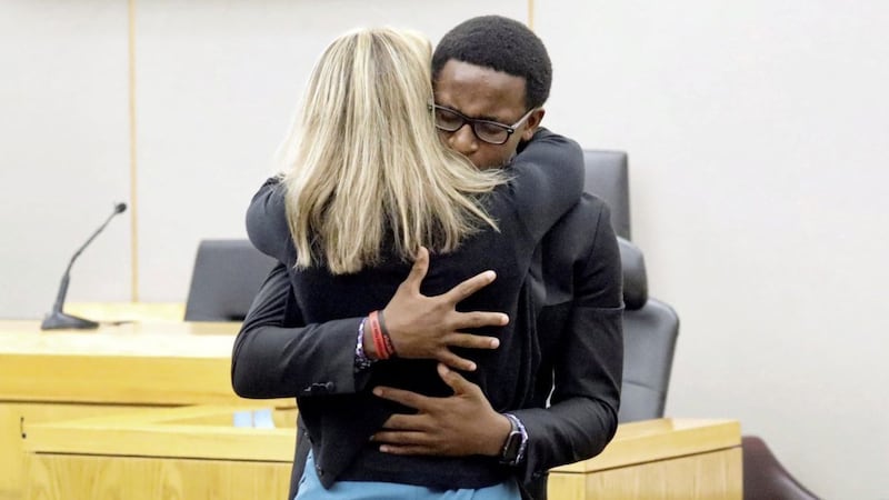 Botham Jean&#39;s younger brother Brandt Jean hugs former Dallas police officer Amber Guyger after telling her that the family forgives her for his murder. Picture by Tom Fox/Pool via Reuters 
