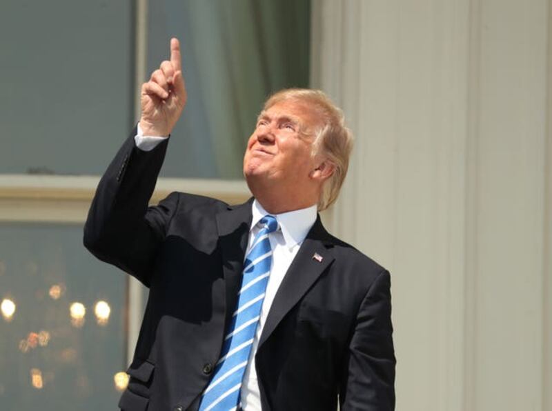 US President Donald Trump looked directly at the eclipse despite advice not to (Andrew Harnik/AP)