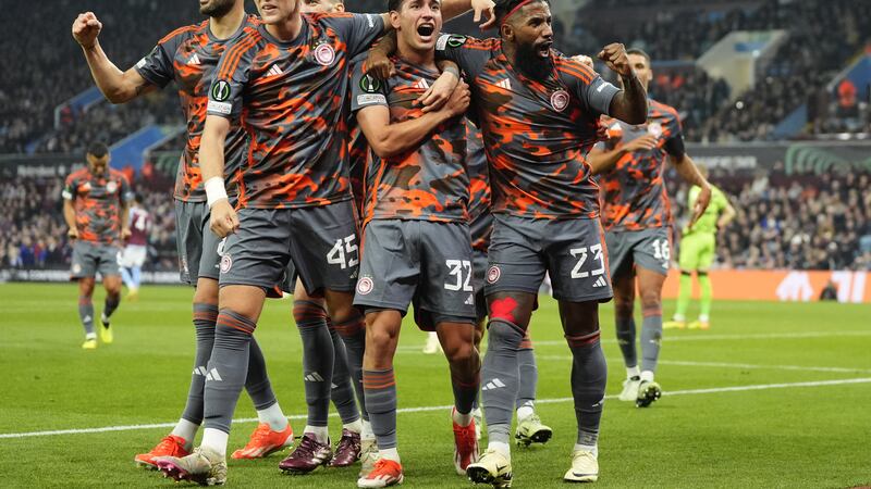 Santiago Hezze (centre) celebrates with his Olympiacos team-mates after scoring their fourth goal
