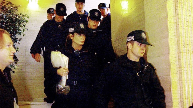 Police leave after their raid on Sinn F&eacute;in offices in Stormont in 2002. 