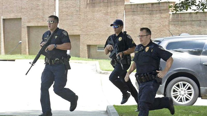 Baton Rouge Police run from the emergency room ramp as a man is taken into custody after a gun was found in his vehicle near the entrance of Our Lady Of The Lake Medical Center. Picture by Hilary Scheinuk, The Advocate/ Associated Press