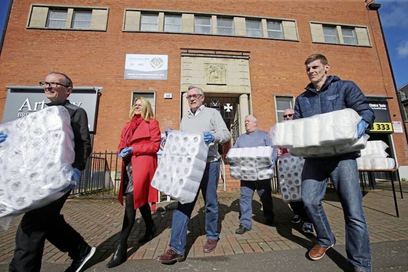 Community workers from west Belfast collect Rescue Packs for the Elderly including toliet rolls, face masks and sanitiser from the Crumlin Road Masonic Hall  Picture Mal McCann. 