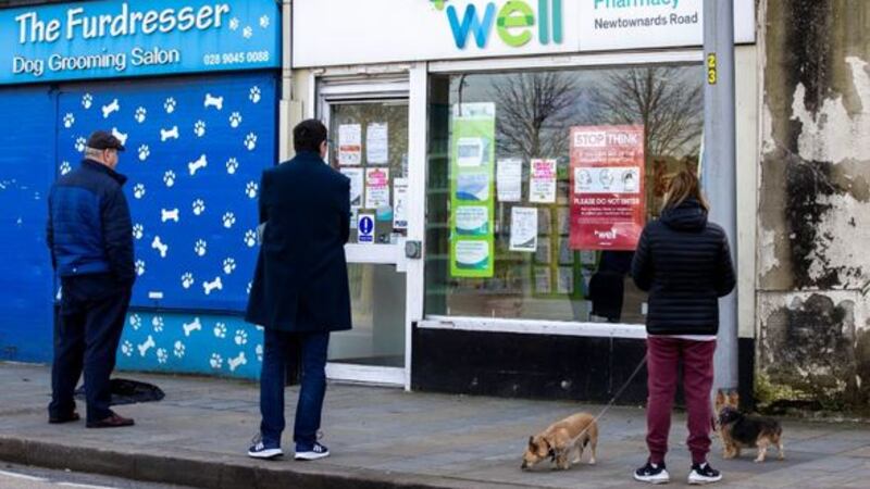 &nbsp;People self isolating waiting to enter a pharmacy on the the Lower Newtownards Road in Belfast.