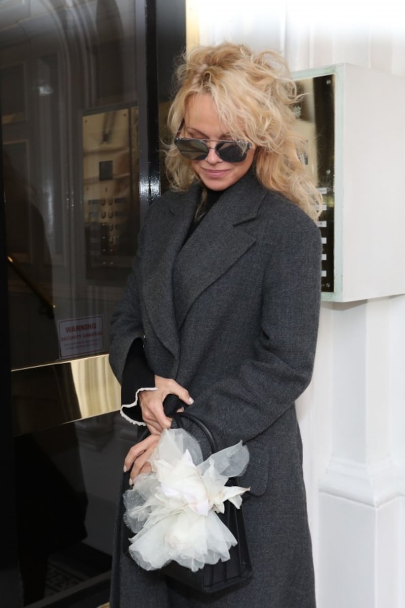 Pamela Anderson arrives to visit Julian Assange at the Ecuadorian embassy in London (Jonathan Brady/PA )