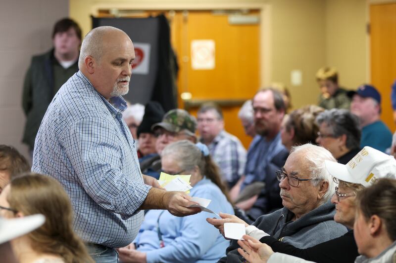 Michael Hilton collects caucus ballots at East Side Christian Church in Council Bluffs, Iowa. (Nikos Frazier/Omaha World-Herald/AP)