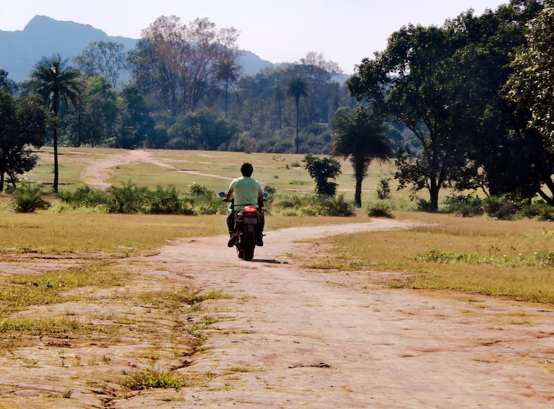 Indian farmer on a moped.