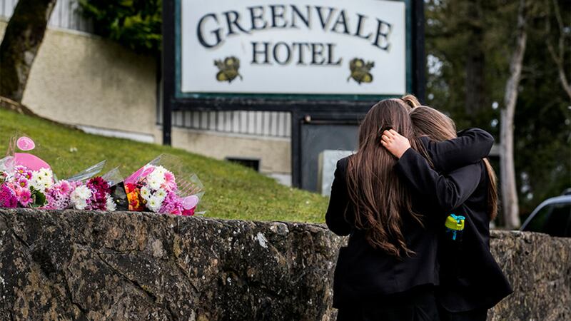 Students from Holy Trinity College leave flowers outside The Greenvale Hotel in Cookstown, Co Tyrone. Picture by Liam McBurney, Press Association
