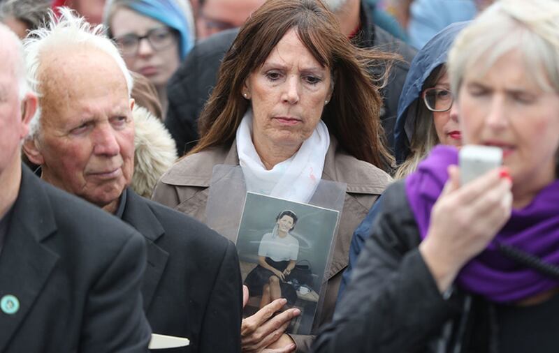 Sheila Wilkinson holds a photograph of her mother, Maggie O'Connor, who was a resident of the home, as people gather to protest at the site of the former Tuam home for unmarried mothers in County Galway, after a mass grave of around 800 babies was uncovered&nbsp;