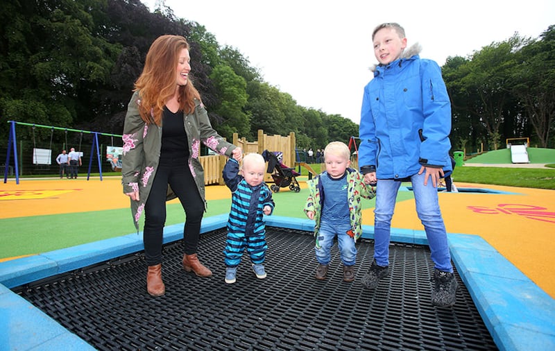 Jill Woods with her three children Bodhi, Rowan and Joshua enjoy the first day of the opening of the newly refurbished Mo Mowlam Play Park on the Stormont Estate. Picture by Mal McCann&nbsp;