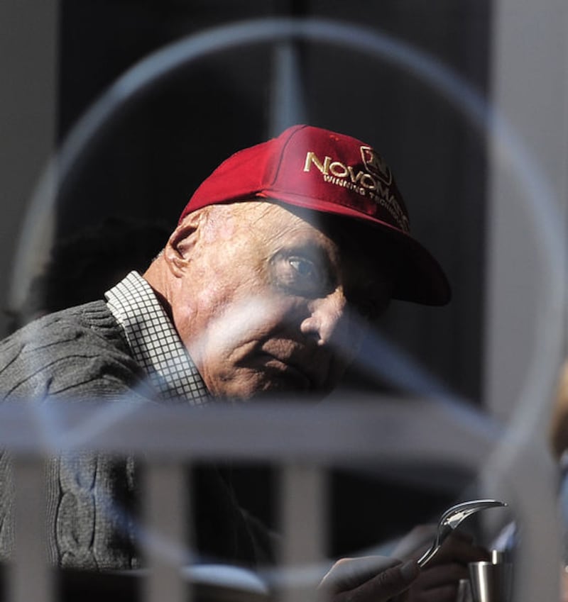 Niki Lauda is pictured through a glass window, during the 2015 Formula One testing, at the Barcelona Catalunya racetrack in Montmelo on February 20 2015.