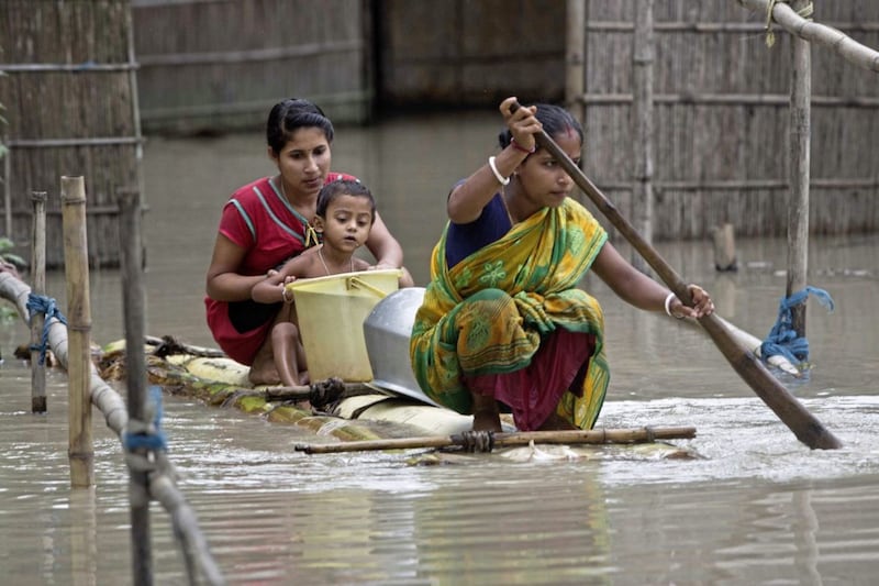 Flood affected Indian villagers move on a banana raft to collect drinking water at Murkata village, east of Gauhati, north eastern Assam state, India, on August 14 2017. Heavy monsoon rains have unleashed landslides and floods that killed dozens of people in recent days and displaced millions more across northern India, southern Nepal and Bangladesh. Picture by Anupam Nath, AP