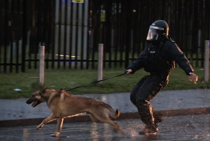 &nbsp;A PSNI officer with a dog on the Springfield road, during further unrest in Belfast. Picture date: Thursday April 8, 2021.