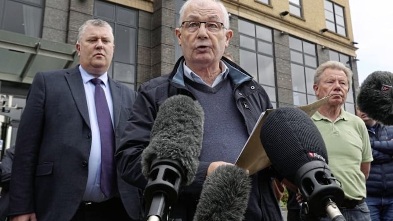 Mickey McKinney spoke to the media with his brothers, John (left) and Joe (right) watched by solicitor Fearghal Shiels, after the prosecution of two former soldiers over three deaths during Northern Ireland&#39;s troubled past were halted. Picture by Liam McBurney/PA Wire 
