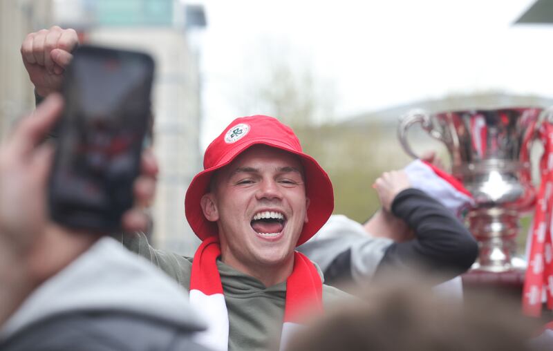 Cliftonville celebrate with the fans during an open top bus tour across Belfast after winning the Irish Cup oat Windsor on Saturday.
PIC COLM LENAGAN