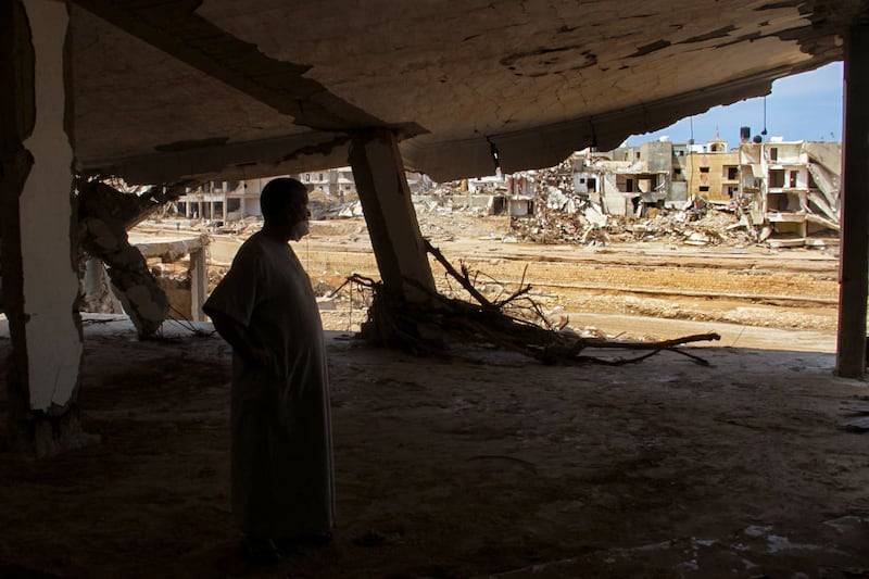 Derna flood survivor Abdul Salam Anwisi looks at destroyed homes