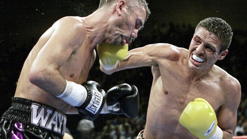Wayne McCullough of Ireland left takes a right from Oscar Larios of Mexico in the sixth round of their WBC super bantamweight championship bout on Saturday July 16 2005 at the MGM Grand Garden Arena in Las Vegas. Lariois won won by technical knockout after 10 rounds.(AP Photo/Laura Rauch) 