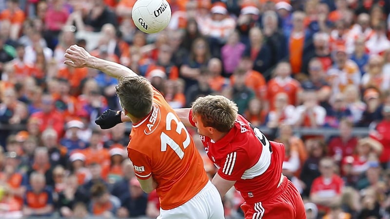 Brendan Rogers rise with Armagh's Andy Murnin during Sunday's Ulster final in Clones. Picture by Philip Walsh