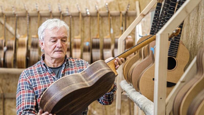 George Lowden, founder and luthier at Lowden Guitars inspects a Sheeran by Lowden guitar in the Co Down-based workshop. 