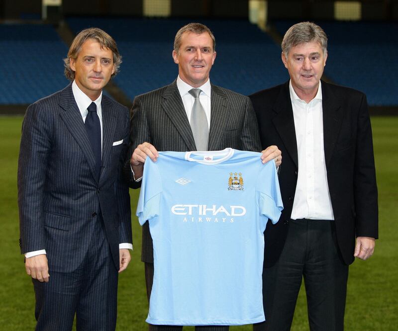 New Manchester City manager Roberto Mancini (left) with chief executive Garry Cook and new assistant-manager Brian Kidd (right) following a press conference at the City of Manchester Stadium on Monday December 21 2009.<br />See above: On This Day 1999.
