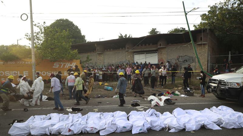 Bodies in bodybags are placed on the side of the road after an accident in Tuxtla Gutierrez, Chiapas state, Mexico, Thursday, December 9, 2021 (AP Photo)&nbsp;