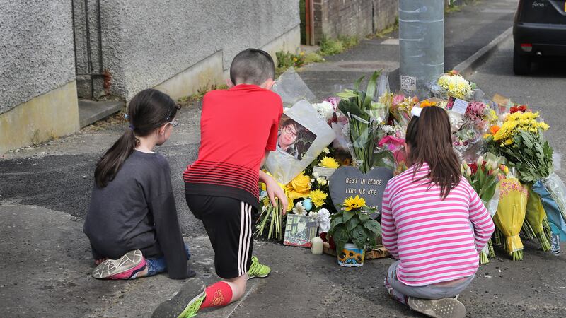 Children examine tributes left at the scene where Lyra McKee was murdered by dissident republicans in the Creggan estate on Thursday. Picture by Margaret McLaughlin<br />&nbsp;