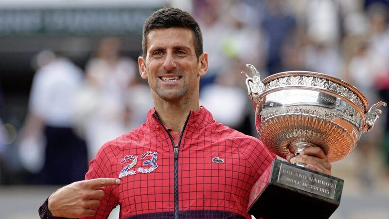 Serbia&#39;s Novak Djokovic points at 23 on his garment as he celebrates winning the men&#39;s singles final match of the French Open tennis tournament against Norway&#39;s Casper Ruud in three sets, 7-6, (7-1), 6-3, 7-5, at the Roland Garros stadium in Paris 