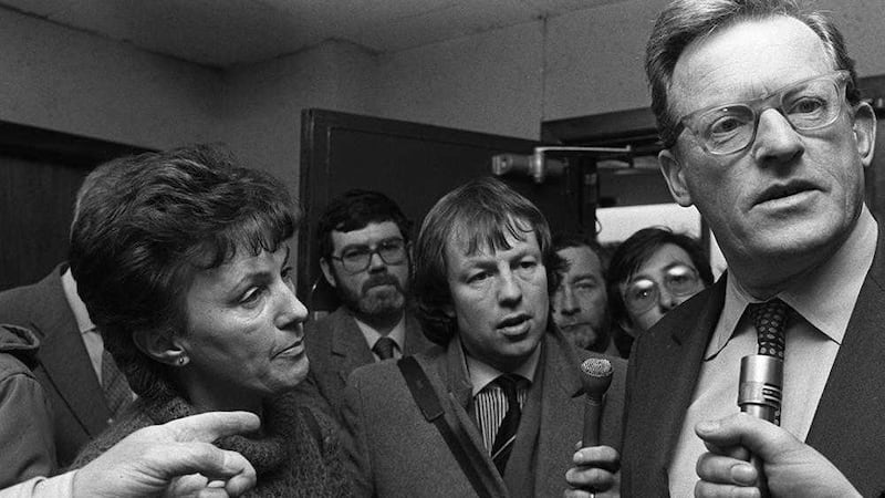 Tom King speaking to journalists and walking with bodyguards at Windsor House in March 1986 