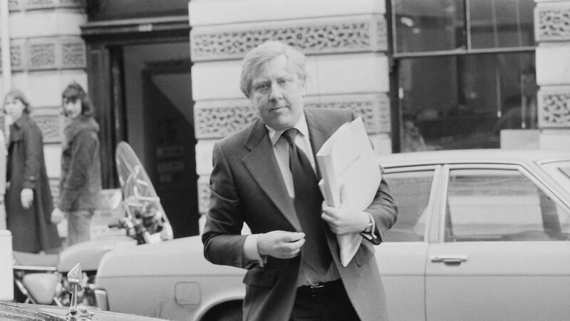 Former Labour minister Roy Hattersley crossing the street carrying papers
