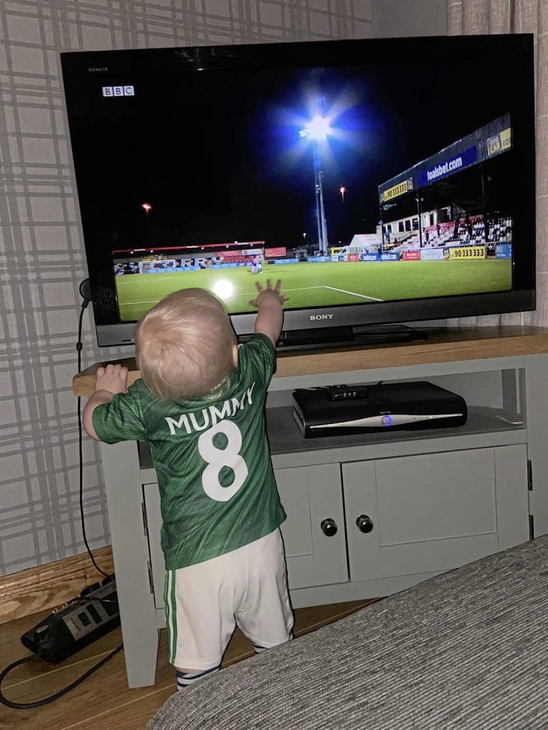 Baby Quinn touches the television screen during her mother's historic night with Northern Ireland against play-off opponents Ukraine last April